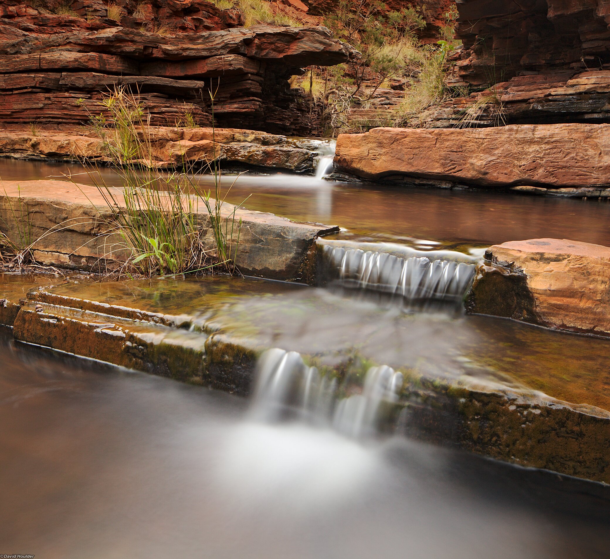 A stream cascading over two rock shelves