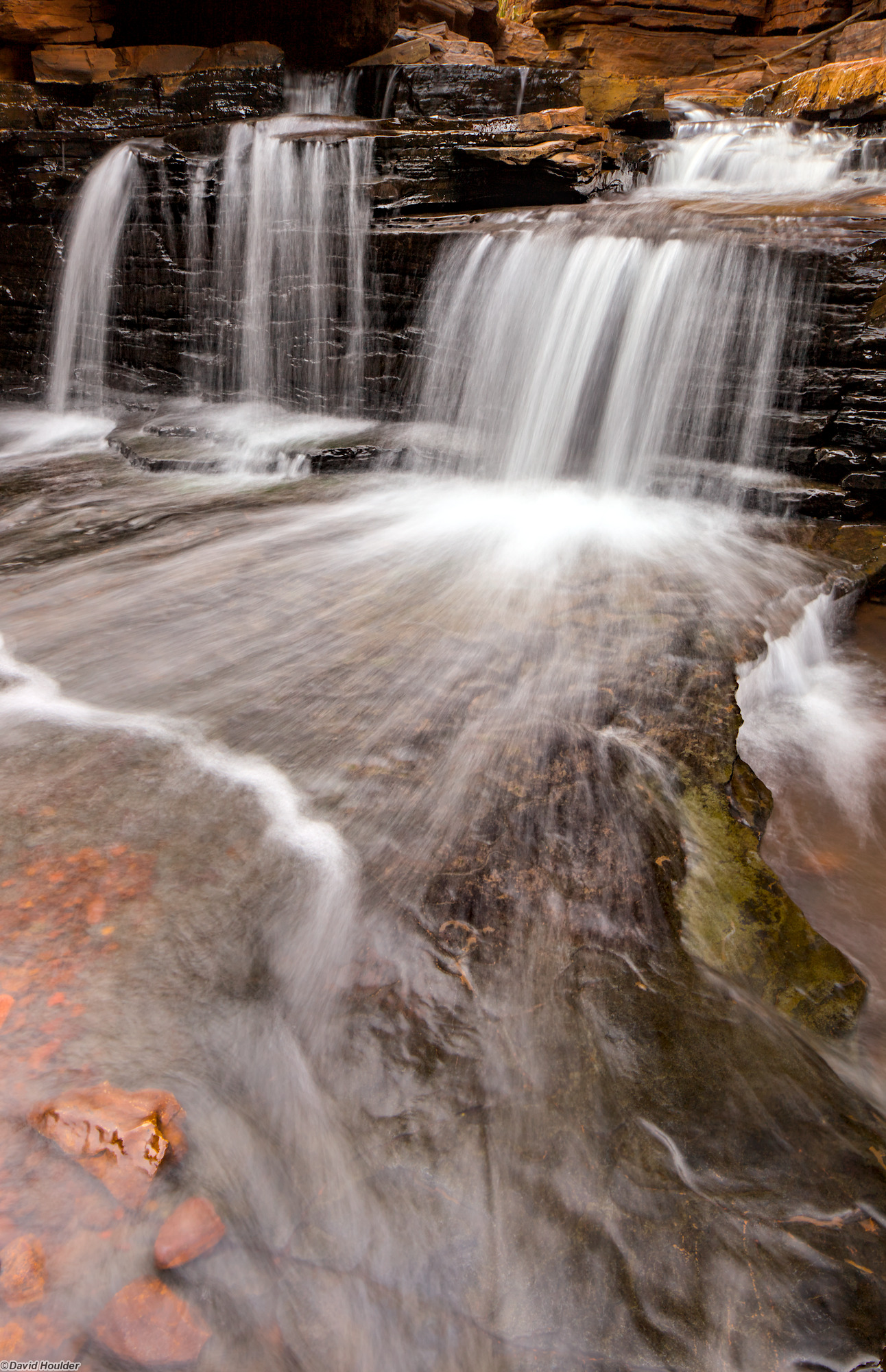 A stream cascading onto a rock shelf